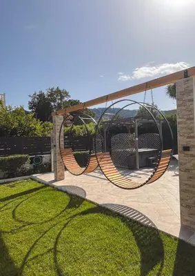 a playground with a swing in a yard at Villa Montefile in Triánta