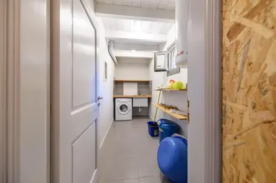 a hallway with a door leading to a laundry room at Aphrodite Villas Halki - Villa Bougainvillea in Halki