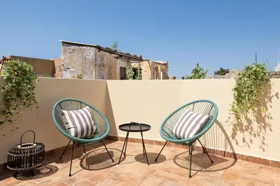 two chairs and a table on a patio at San Antonio Luxury Apartments, Medieval Town in Rhodes Town