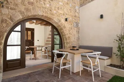 a patio with tables and chairs in a building at San Antonio Luxury Apartments, Medieval Town in Rhodes Town