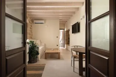 a hallway with a door and a table in a room at San Antonio Luxury Apartments, Medieval Town in Rhodes Town