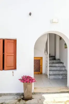 a hallway with a door and a potted plant at Barvas studios Lindos in Líndos