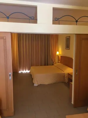 a bedroom with a king sized bed in a room at Coloma Apartments Pefkos in Pefki Rhodes