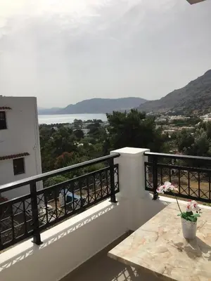 a balcony with a view of the water at Coloma Apartments Pefkos in Pefki Rhodes