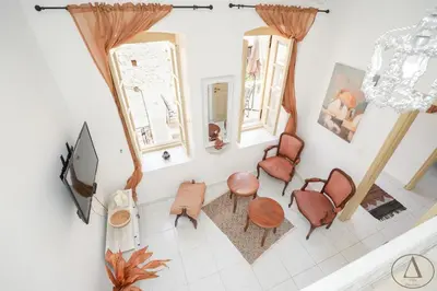 an overhead view of a living room with chairs and a tv at Mansion House(est.c1890)-Daedalus in Halki
