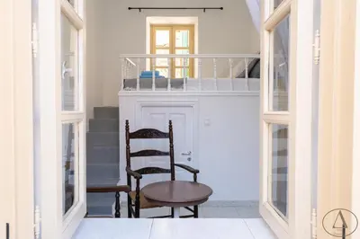 a hallway with a chair and a bunk bed at Mansion House(est.c1890)-Daedalus in Halki
