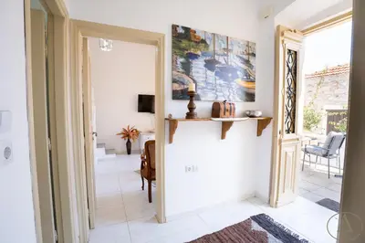 a hallway with a door leading to a living room at Mansion House(est.c1890)-Daedalus in Halki