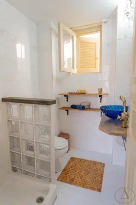 a bathroom with a toilet and a sink at Mansion House(est.c1890)-Daedalus in Halki