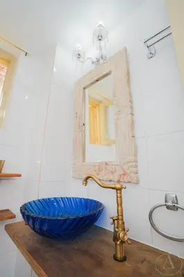 a bathroom with a blue bowl and a mirror at Mansion House(est.c1890)-Daedalus in Halki