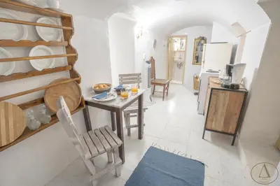 a kitchen and dining room with a table and chairs at Mansion House(est.c1890)-Daedalus in Halki