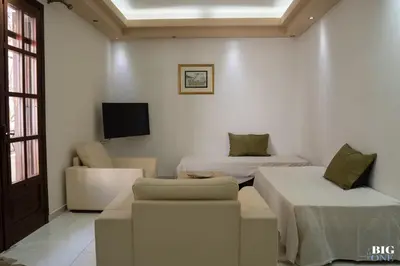 a room with two beds and a couch and a tv at The BIG one!! in Rhodes Town
