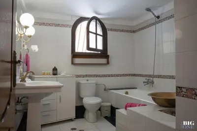 a bathroom with a sink and a toilet and a tub at The BIG one!! in Rhodes Town