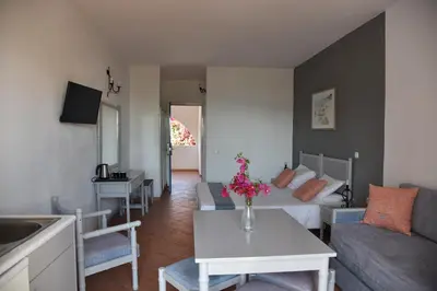 a living room with a couch and a table at Boutique Hotel Tilos Mare in Livadia
