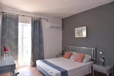 a bedroom with a bed and a window at Boutique Hotel Tilos Mare in Livadia