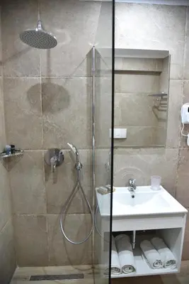 a bathroom with a shower and a sink at Boutique Hotel Tilos Mare in Livadia