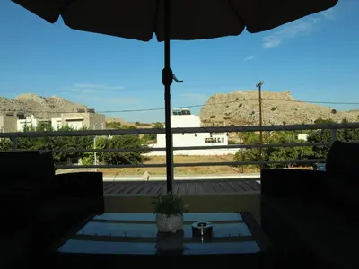 a view of a balcony with an umbrella at Summer Lovin in Haraki