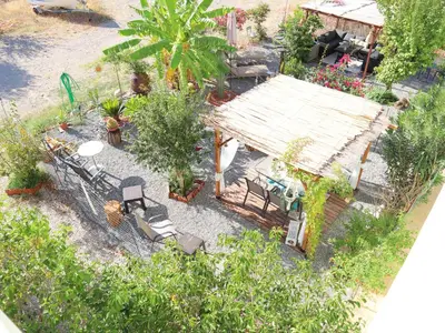 an overhead view of a garden with a house at Summer Lovin in Haraki