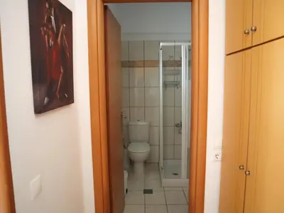 a bathroom with a toilet and a glass shower at Summer Lovin in Haraki