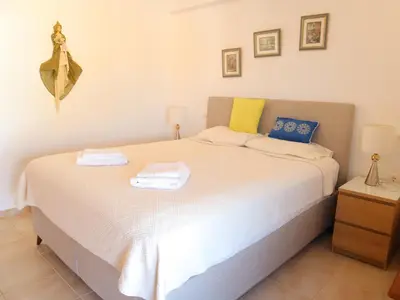 a bedroom with a bed with two towels on it at Summer Lovin in Haraki