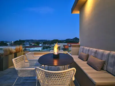 a patio with a table and chairs on a balcony at Chrissiida Villa in Ialyssos