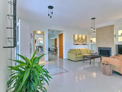 a living room with a couch and a fireplace at Chrissiida Villa in Ialyssos