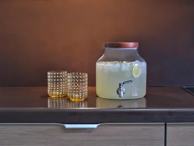 a mason jar with three candles on a table at Chrissiida Villa in Ialyssos