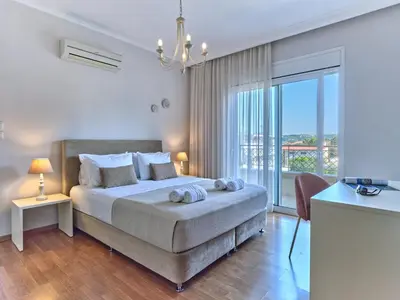 a bedroom with a bed and a large window at Chrissiida Villa in Ialyssos