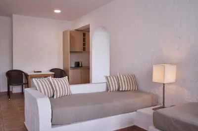 a living room with a couch and a table at The Apartments by Esperia in Rhodes Town