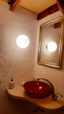 a bathroom with a red sink and a mirror at Mannashouse in Émbonas