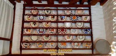 a wall filled with plates on a wall at Mannashouse in Émbonas