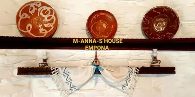 a shelf with three plates on a wall at Mannashouse in Émbonas