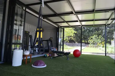 a garage with a gym with green grass at Cook's Club Ialysos Rhodes in Ialyssos