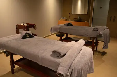 two beds in a room with towels on them at Cook's Club Ialysos Rhodes in Ialyssos