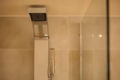 a shower in a bathroom with a shower head at Villa Anaflo in Haraki