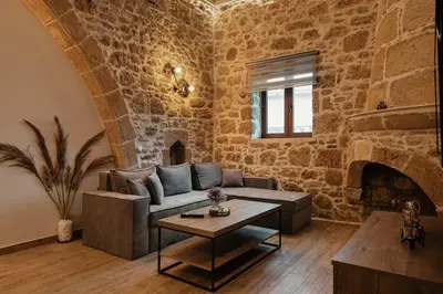 a living room with a couch and a fireplace at Villa Anaflo in Haraki