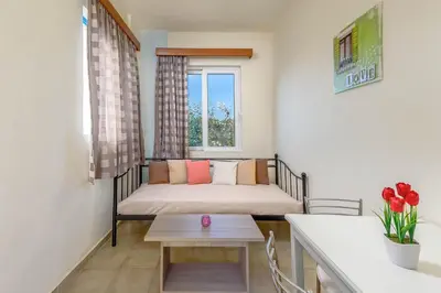a small room with a bed and a table at Litsas Studios in Phanaes