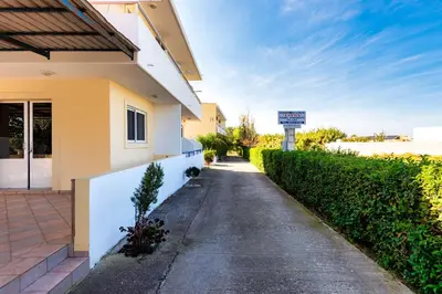 a driveway of a house with a sign on the side at Litsas Studios in Phanaes