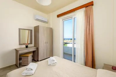 a bedroom with a bed and a window with a view at Litsas Studios in Phanaes