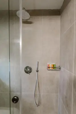a bathroom with a shower with a glass door at Manolis Loft Apartment, Rhodes Town in Rhodes Town
