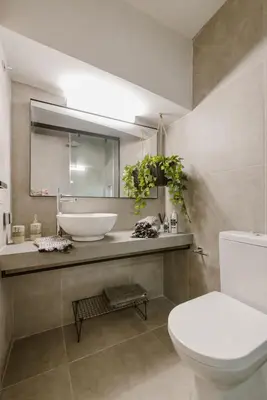 a bathroom with a sink and a toilet and a mirror at Manolis Loft Apartment, Rhodes Town in Rhodes Town