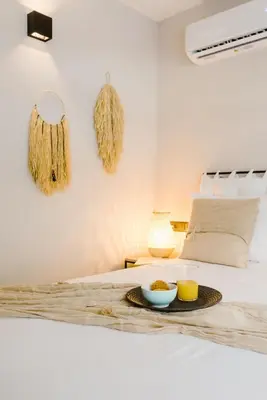 a tray with a bowl of food on a bed at Manolis Loft Apartment, Rhodes Town in Rhodes Town