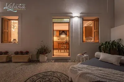 a bedroom with a bed and a dining room at Panthea Valasia Boutique Villa in Líndos