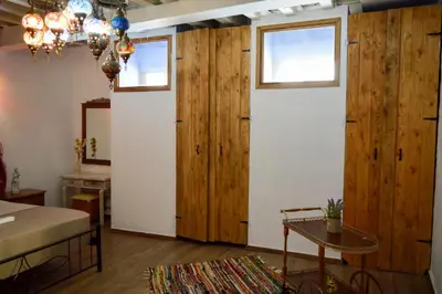 a living room with wood paneled walls and a table at Fatma Hanoum boutique hotel in Rhodes Town