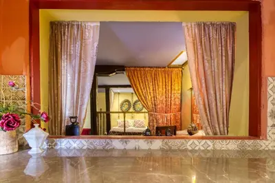a large mirror in a room with a bed in it at Fatma Hanoum boutique hotel in Rhodes Town