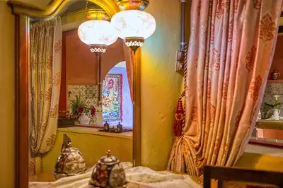 a mirror in a room with curtains and a table at Fatma Hanoum boutique hotel in Rhodes Town