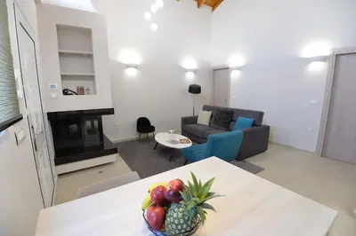 a living room with a table with a bowl of fruit at Kameiros Treasure Villa in Kalavárda