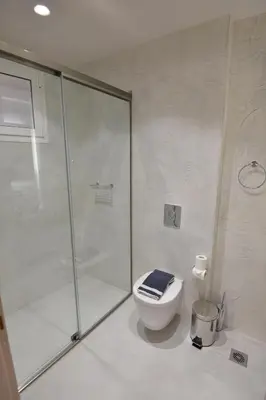 a bathroom with a glass shower and a toilet at Kameiros Treasure Villa in Kalavárda