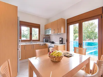 a kitchen with a table with a basket of bananas on it at Holiday home in Kiotari near the beach in Kiotari