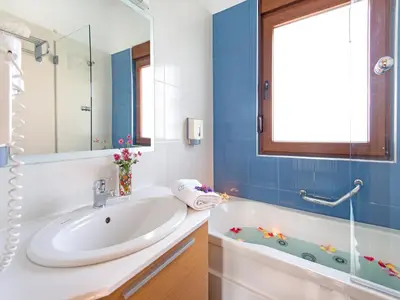 a bathroom with a sink and a bath tub at Holiday home in Kiotari near the beach in Kiotari