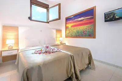 a bedroom with a large bed with flowers on it at Holiday home in Kiotari near the beach in Kiotari